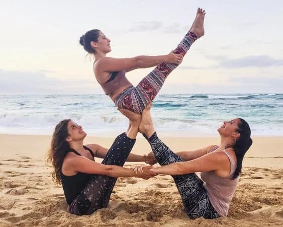 Hai người hỗ trợ nhau trong tư thế đứng bằng tay tạo hình yoga đôi