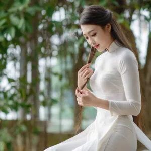 Tóc dài thẳng được buộc nửa đầu dịu dàng, phù hợp chụp ảnh kỷ yếu với áo dài